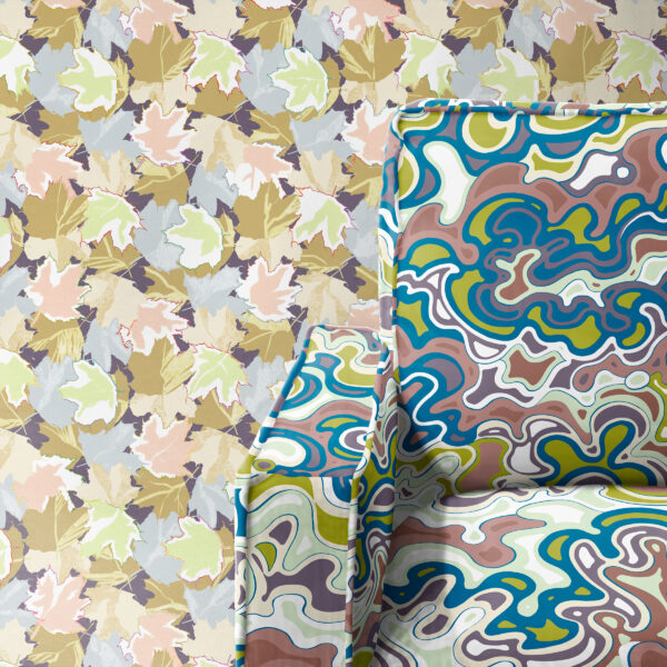 Textile and wallpaper designs from the Oh Canada collection. Maple on wall and Current on chair.