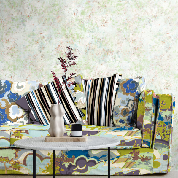 The Oh Canada collection of textiles and wallcoverings. Taylor Head on sofa, Lichen and 49 on pillows and Splash on wall.